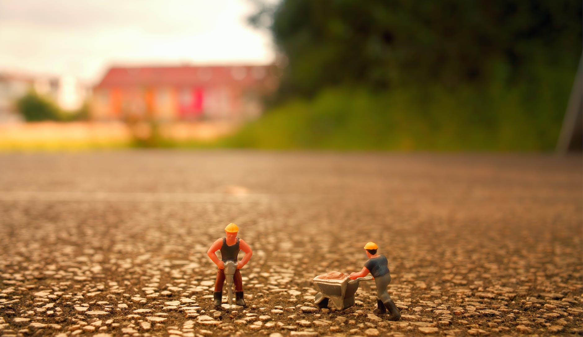 selective focus photography of two men builder figurines